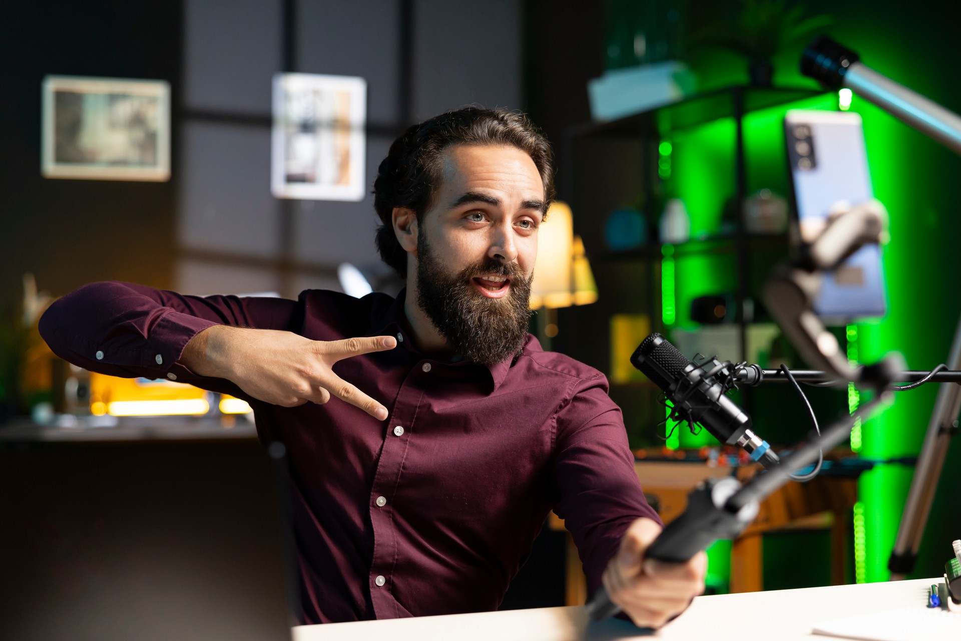 Influencer doing peace sign in front on cellphone attached to selfie stick